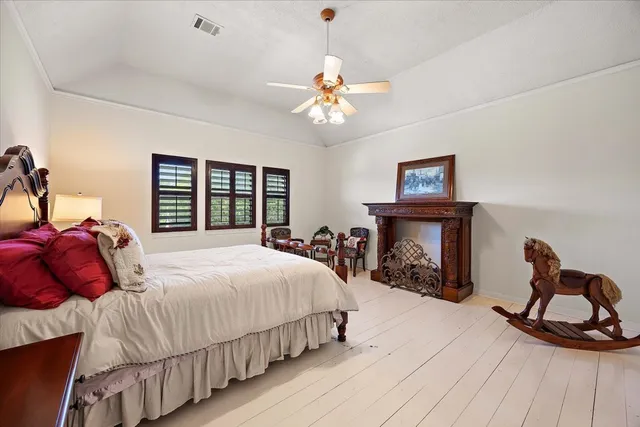 a bedroom with bed and a fireplace