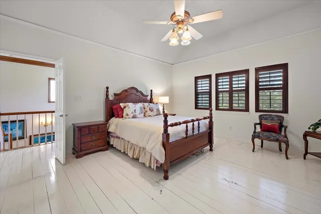 a bedroom with a large bed a lamp and a chandelier