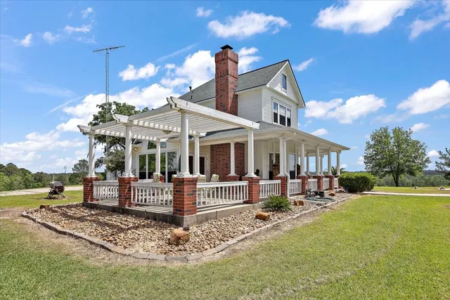a front view of a house with a yard table and chairs