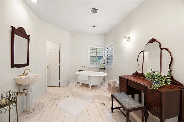 a living room with furniture and a mirror