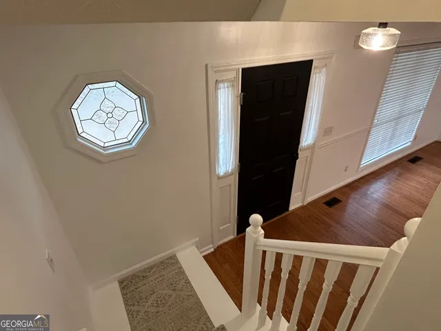 a view of balcony with wooden floor and fence