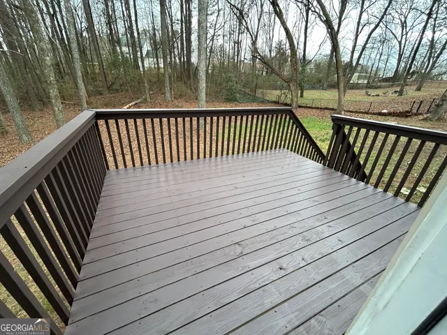a view of a yard with wooden fence