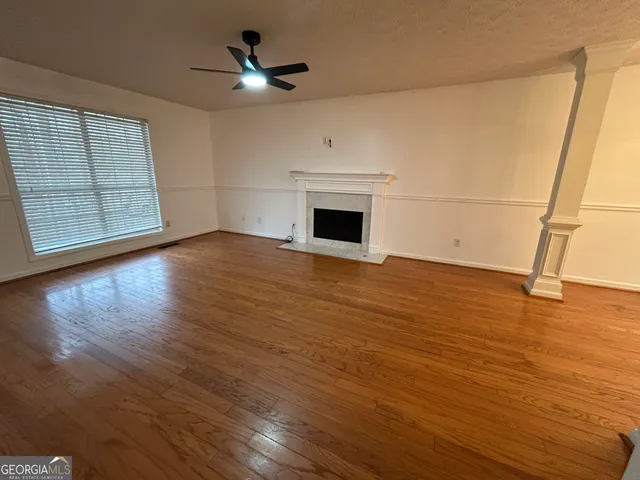 wooden floor in an empty room with a fireplace