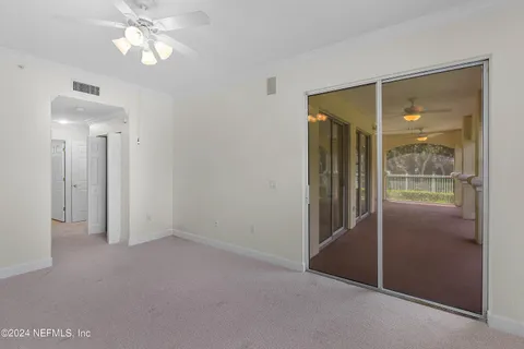 an empty room that has a glass door and shower