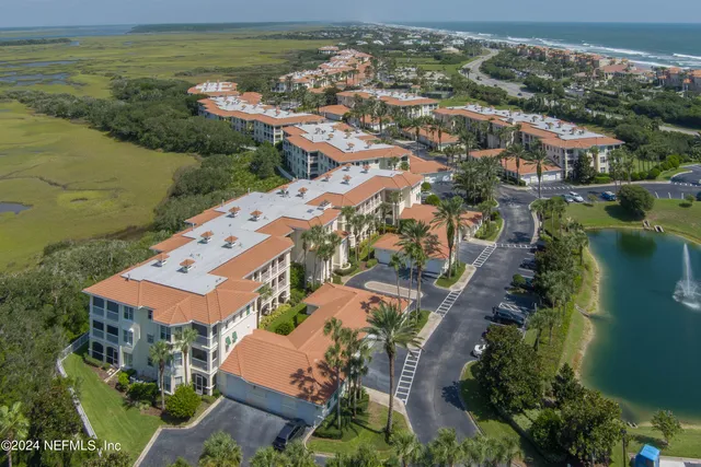 an aerial view of residential houses with outdoor space and river