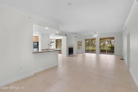 a view of an empty room with a kitchen
