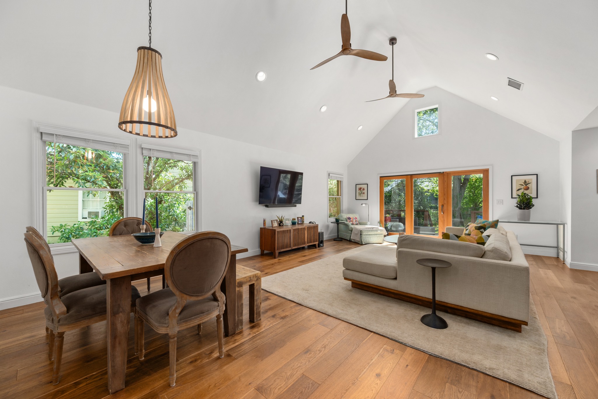 6103 Bull Creek Road Austin, TX 78757 - Photo 12 of 29 Dining space featuring a high ceiling, light wood finished floors, french doors, a ceiling fan, and recessed lighting