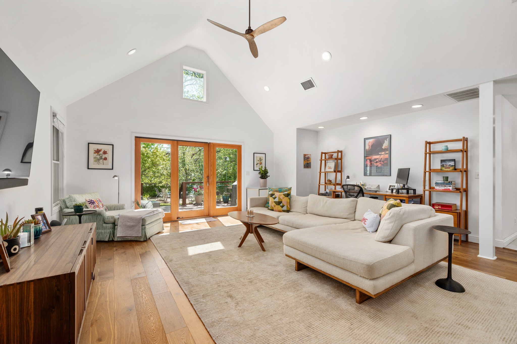 6103 Bull Creek Road Austin, TX 78757 - Photo 13 of 29 Living area featuring french doors, a high ceiling, light wood finished floors, a ceiling fan, and recessed lighting