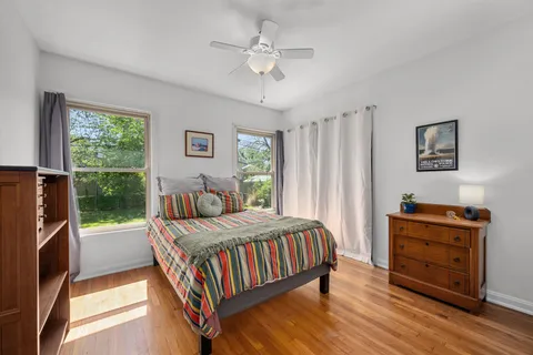 a living room with a bed and a table