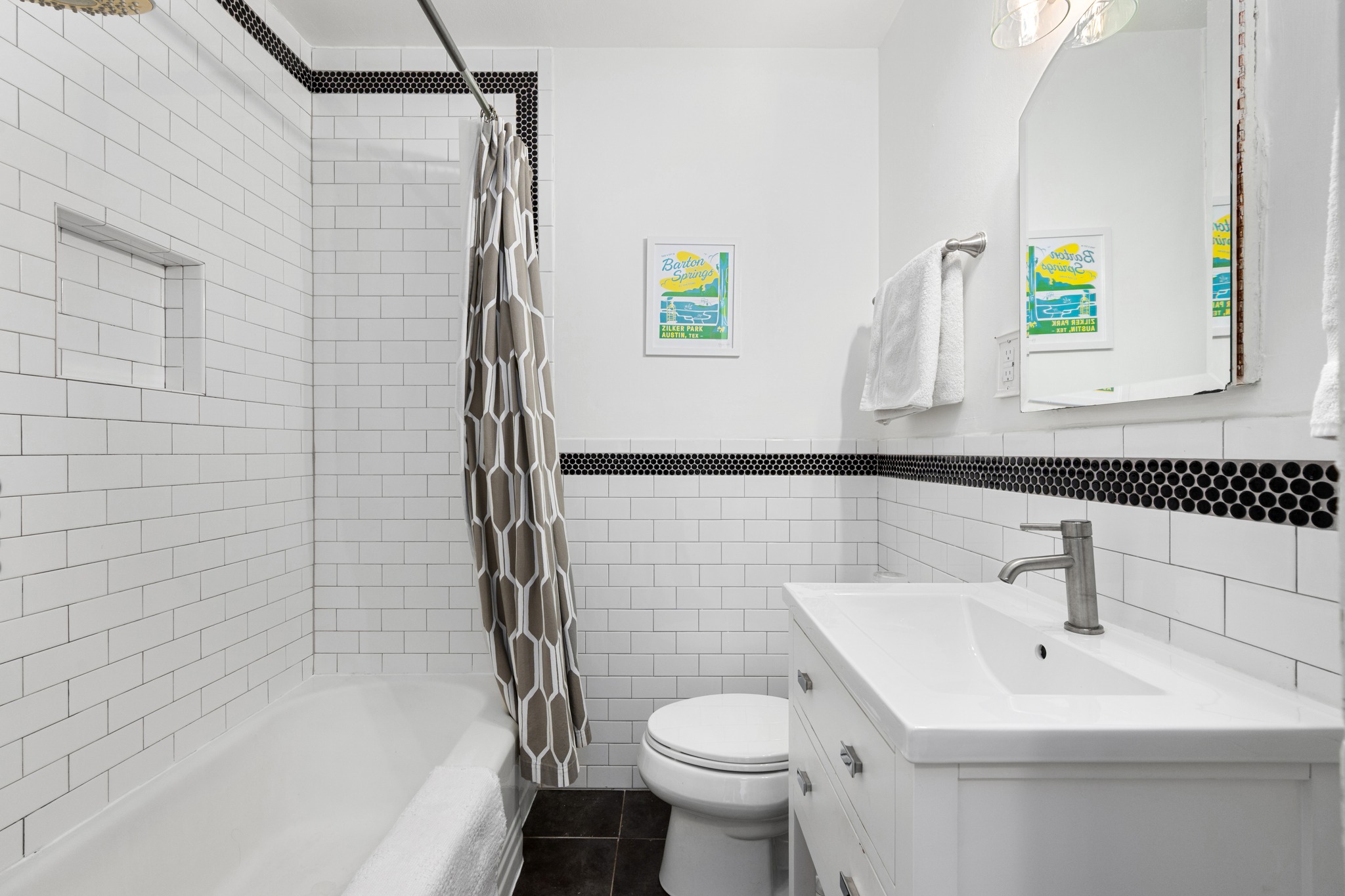 6103 Bull Creek Road Austin, TX 78757 - Photo 20 of 29 Bathroom with tile walls, vanity, shower / bath combo with shower curtain, a wainscoted wall, and dark tile patterned flooring