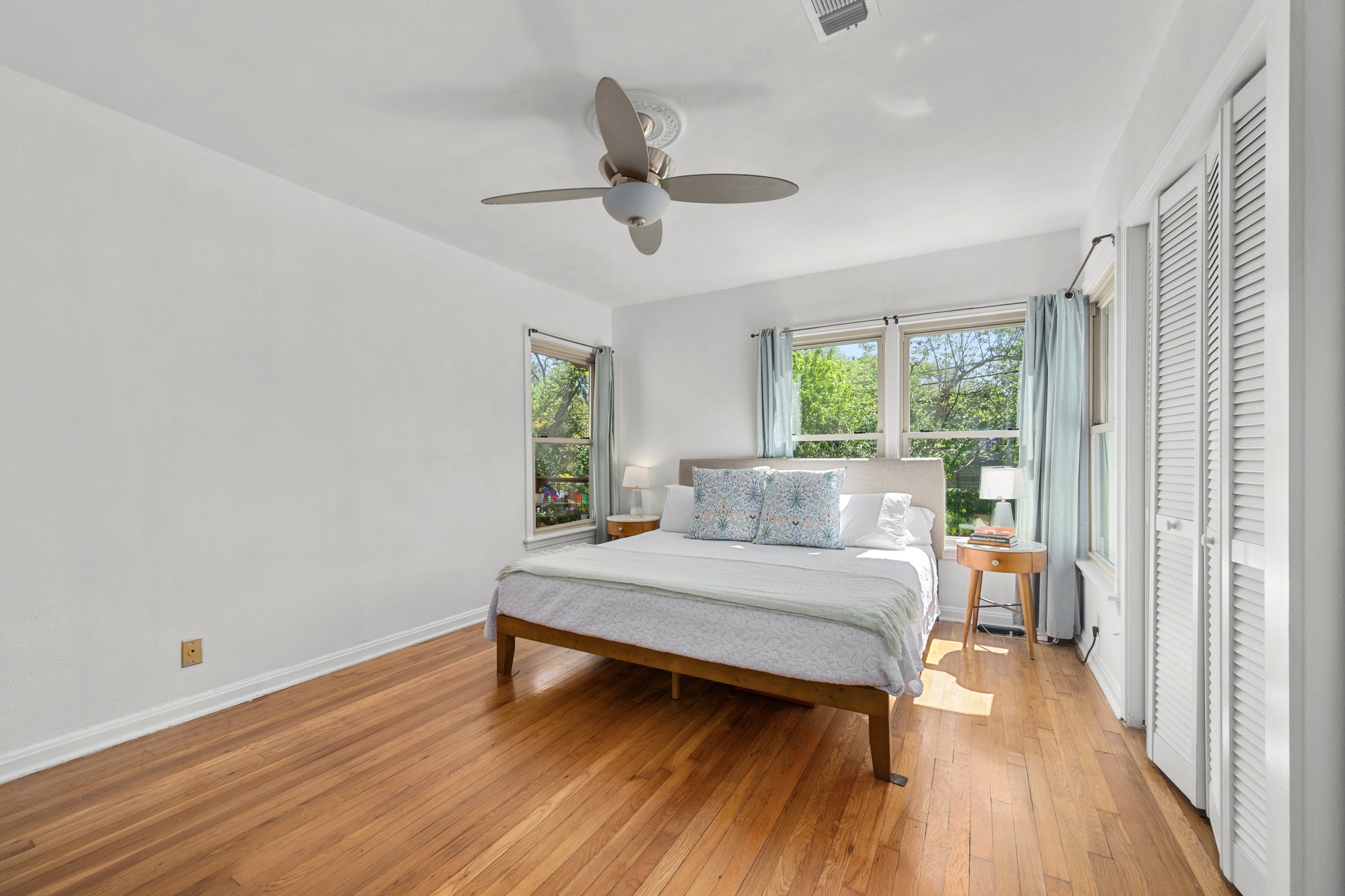 6103 Bull Creek Road Austin, TX 78757 - Photo 21 of 29 Bedroom with light wood-type flooring and ceiling fan