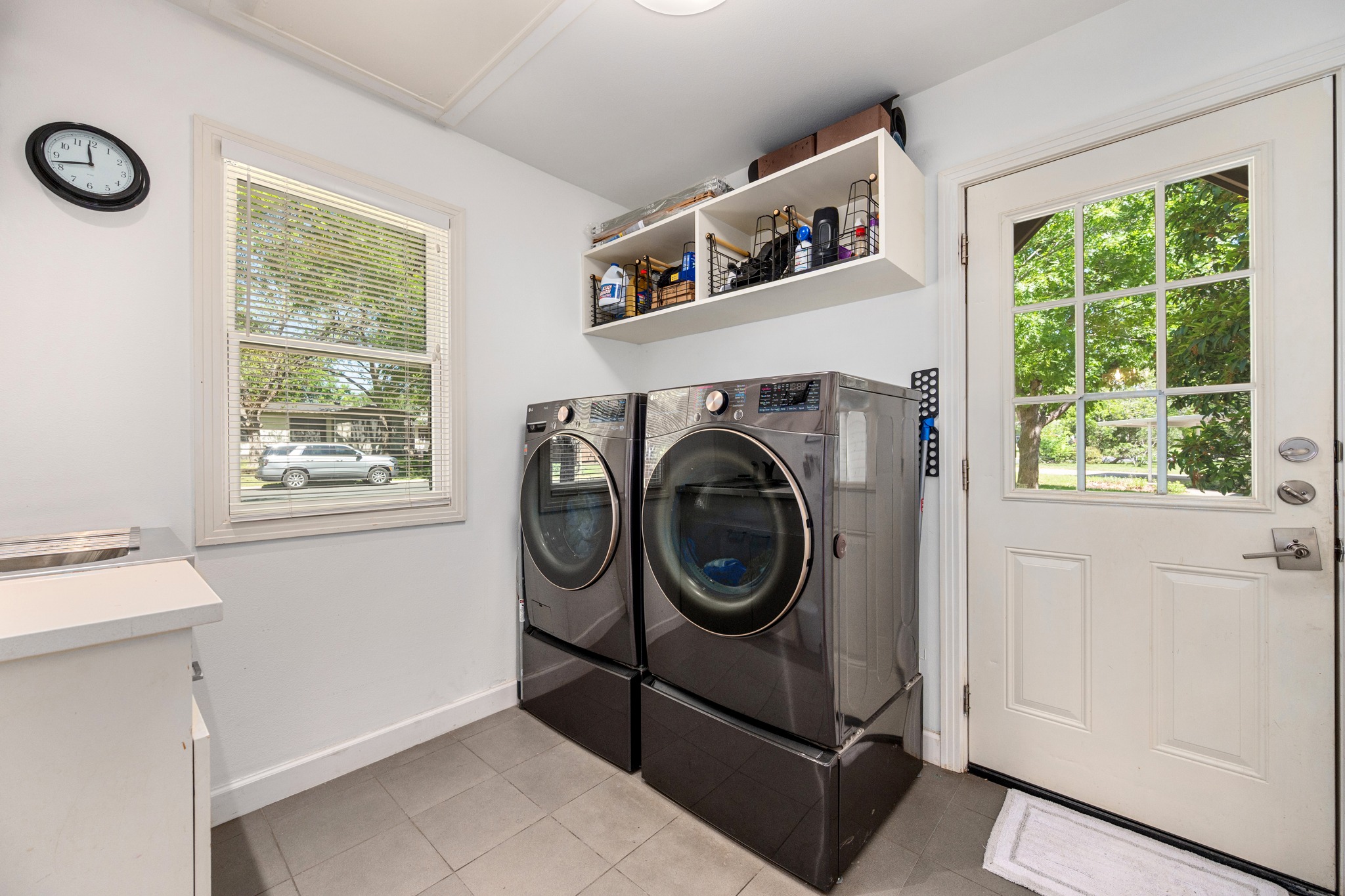 6103 Bull Creek Road Austin, TX 78757 - Photo 23 of 29 Laundry area featuring washer and dryer and light tile patterned floors