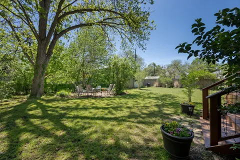 a view of deck with table and chairs a barbeque with wooden floor and fence