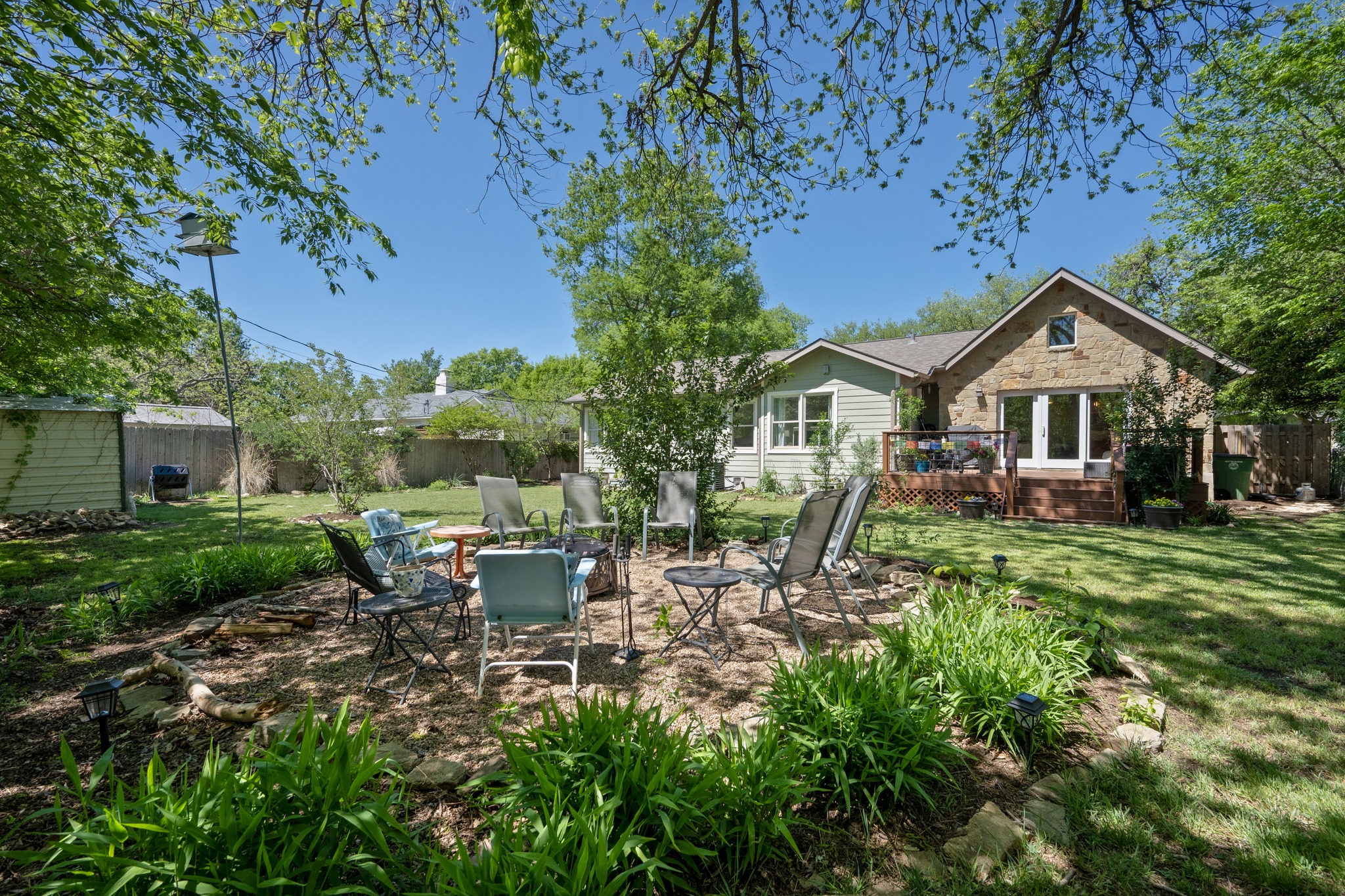 6103 Bull Creek Road Austin, TX 78757 - Photo 26 of 29 Rear view of house with a deck, a fire pit, a patio area, and a storage shed