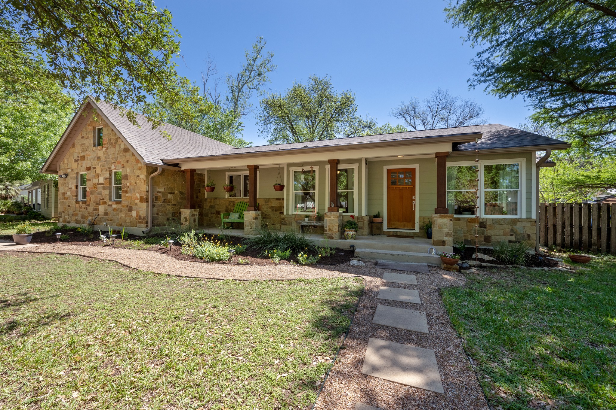 6103 Bull Creek Road Austin, TX 78757 - Photo 28 of 29 Ranch-style house with stone siding, a porch, and roof with shingles