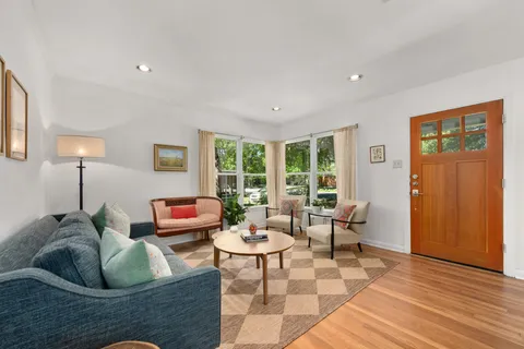 a living room with furniture and wooden floor