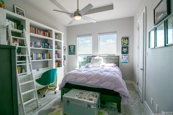 a bed room with a bed and a book shelf