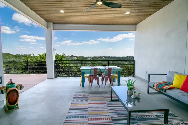 a view of a patio with a table chairs and a backyard
