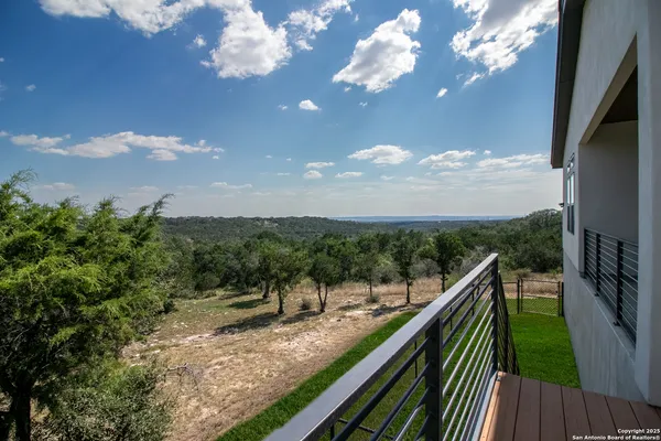 a view of trees and sky from balcony