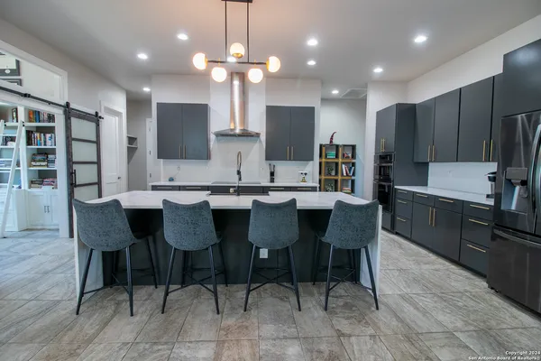a large kitchen with a table and chairs