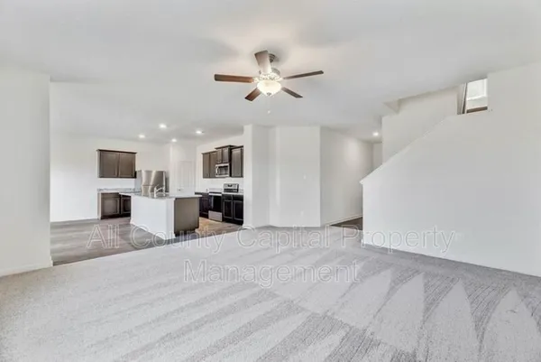 a view of a kitchen with a sink and a ceiling fan