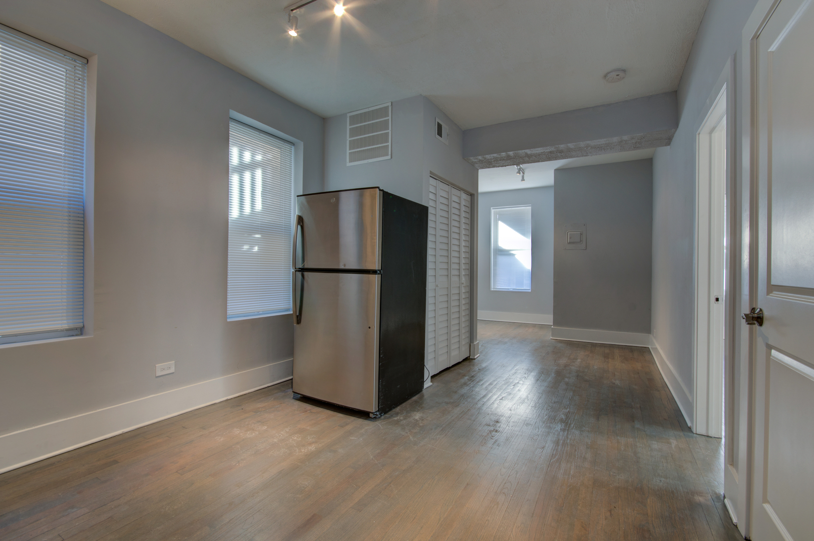 1706 South Carpenter Street, Unit 1R Chicago, IL 60608 - Photo 3 of 8 a view of a refrigerator in kitchen and wooden floor