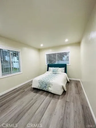a bed sitting in a bedroom next to a window