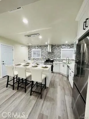 a kitchen with a sink cabinets and wooden floor