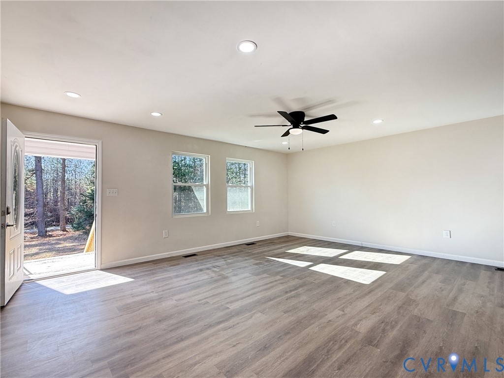 569 Gaulding Rd Hill La Crosse, VA 23950 - Photo 5 of 24 an empty room with wooden floor and windows