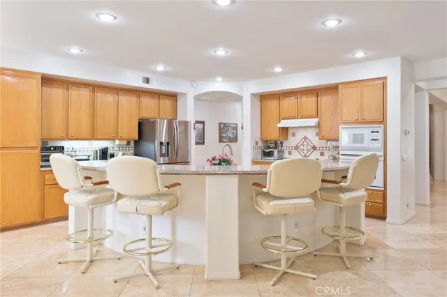 a kitchen with stainless steel appliances granite countertop a sink and cabinets