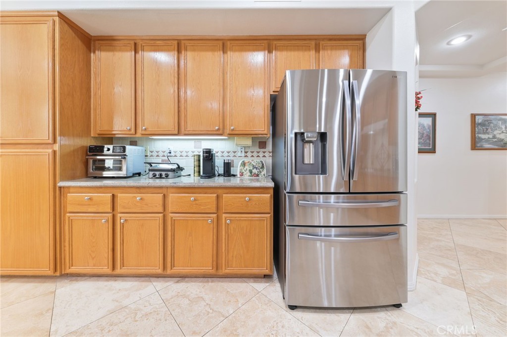 12830 Wildflower Lane Riverside, CA 92503 - Photo 15 of 34 a kitchen with stainless steel appliances granite countertop a refrigerator a sink and cabinets