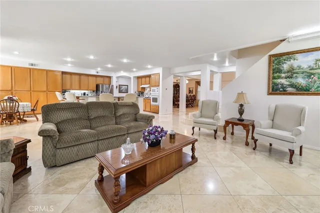 a living room with furniture a fireplace and a large window