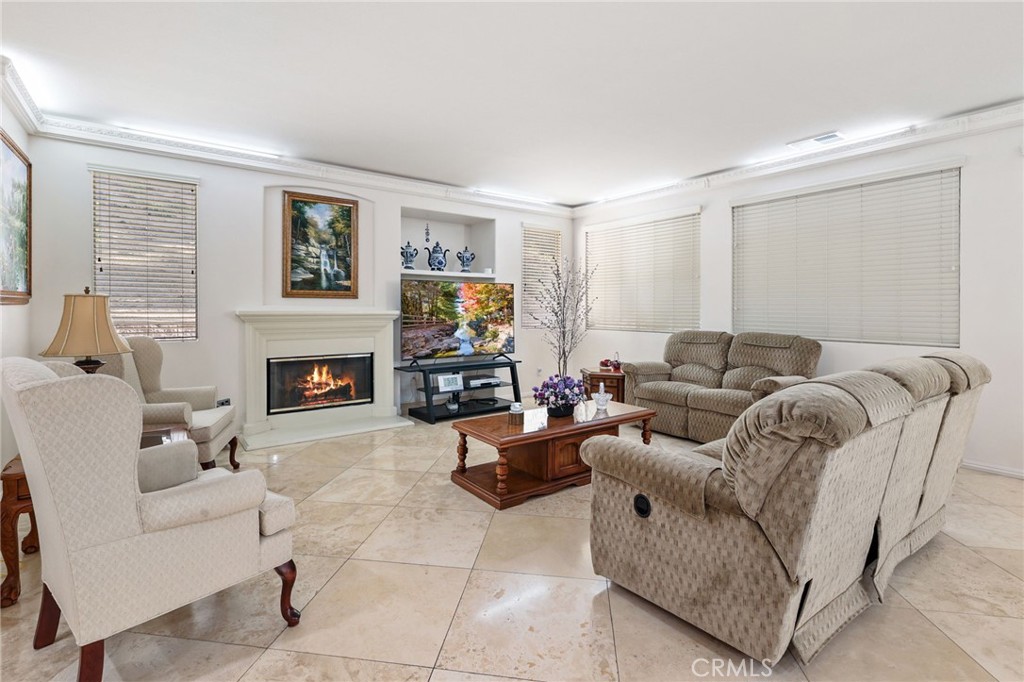 12830 Wildflower Lane Riverside, CA 92503 - Photo 18 of 34 a living room with furniture a fireplace and a large window