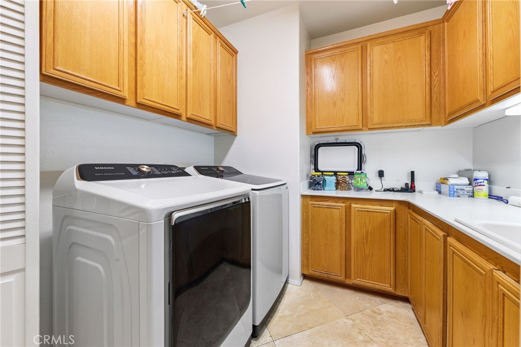 12830 Wildflower Lane Riverside, CA 92503 - Photo 19 of 34 a utility room with sink dryer and washer