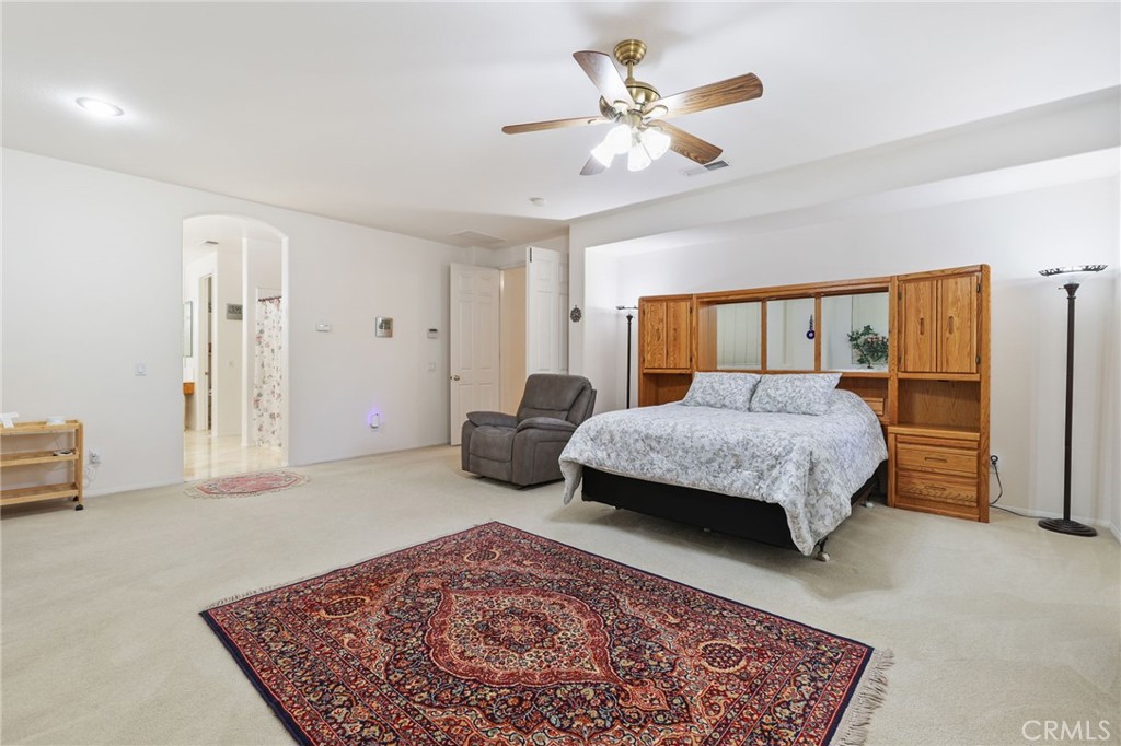 12830 Wildflower Lane Riverside, CA 92503 - Photo 23 of 34 a bedroom with a bed a couch and a dresser