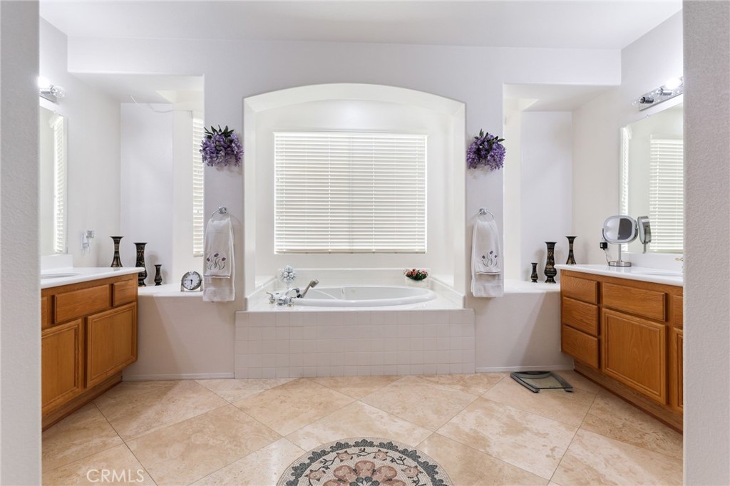 12830 Wildflower Lane Riverside, CA 92503 - Photo 24 of 34 a bathroom with a tub sink and mirror