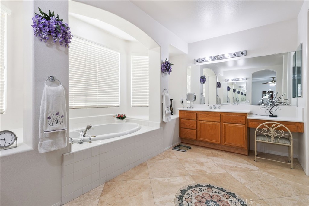 12830 Wildflower Lane Riverside, CA 92503 - Photo 25 of 34 a spacious bathroom with a tub sink and mirror