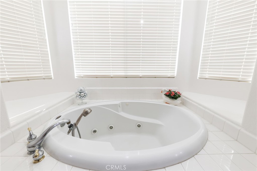 12830 Wildflower Lane Riverside, CA 92503 - Photo 26 of 34 a white bath tub sitting in a bathroom