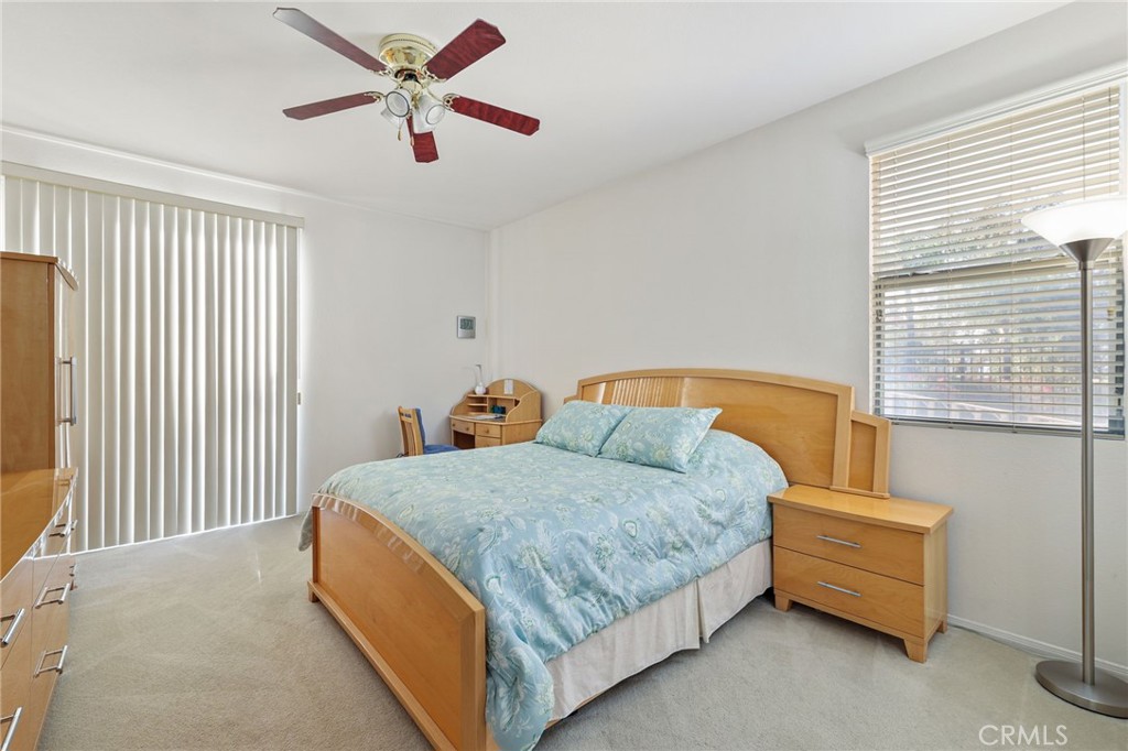 12830 Wildflower Lane Riverside, CA 92503 - Photo 29 of 34 a bedroom with a bed and a chandelier
