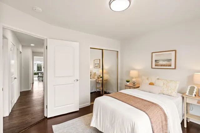 a bedroom with a bed and wooden floor