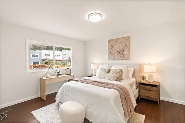 a bedroom with a bed and a window