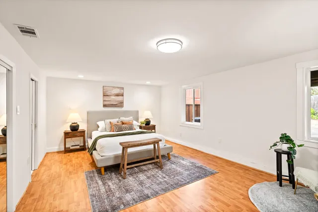 a bedroom with a bed and a potted plant