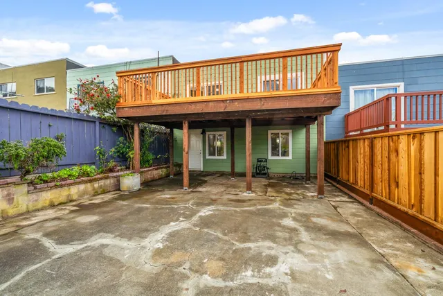 a view of brick house with large windows and plants