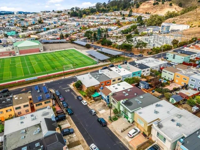 an aerial view of residential houses with outdoor space