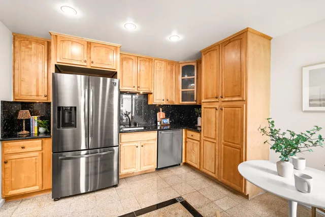 a kitchen with stainless steel appliances a refrigerator stove microwave and sink