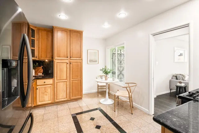 a living room with furniture a wooden floor and next to a window