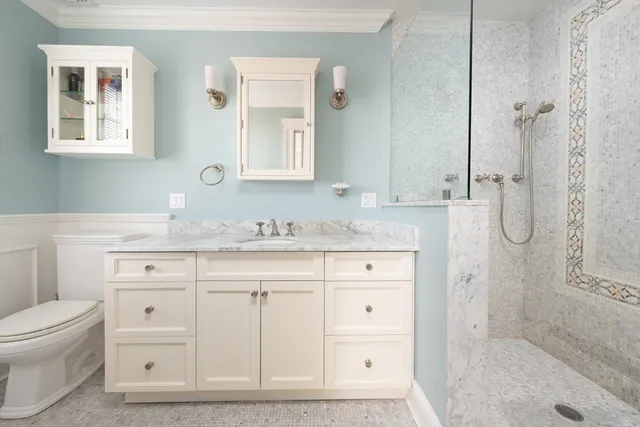 a bathroom with a granite countertop sink toilet and shower