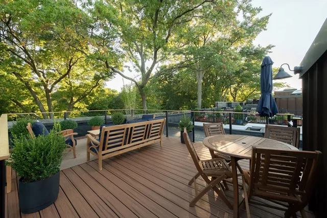 a view of a chairs and table on the wooden deck
