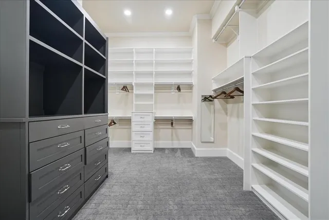 a view of walk in closet with empty racks