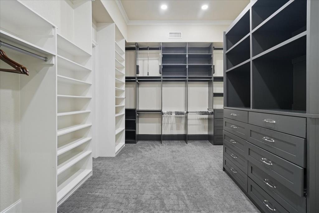6807 Lupton Drive Dallas, TX 75225 - Photo 19 of 40 a view of walk in closet with empty racks